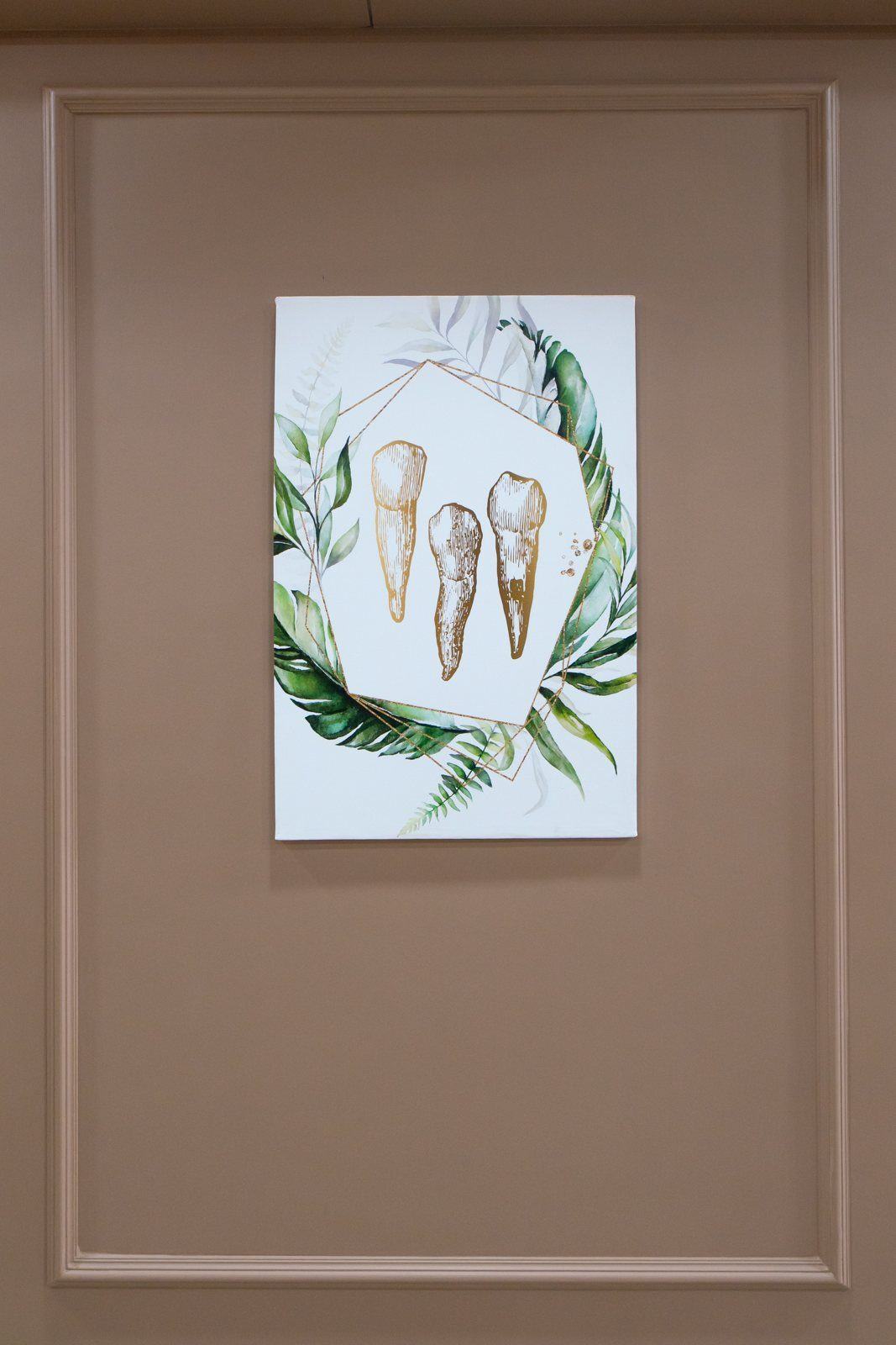 Framed tooth-themed artwork on clinic wall