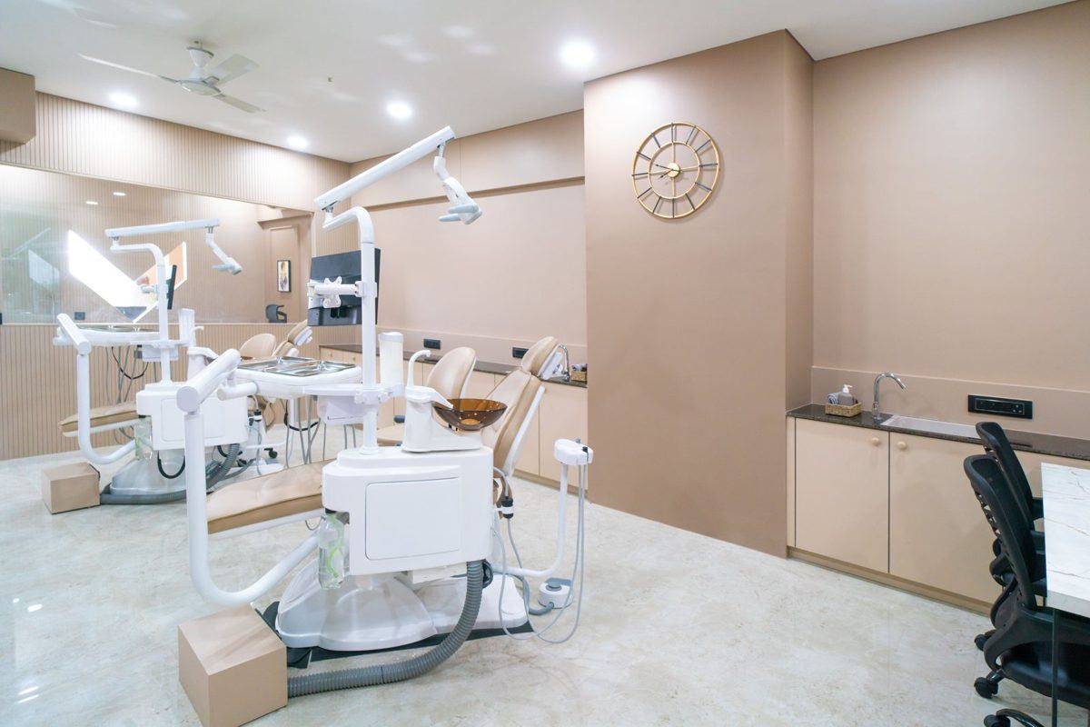 Wide treatment room view with foreground dental chair